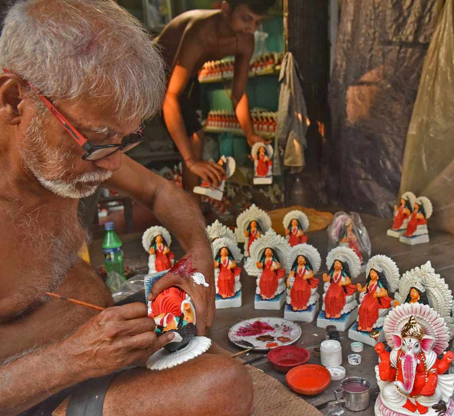 An artist at Kumortuli gives finishing touches to idols of Laxmi and Ganesh ahead of Poila Baisakh (Bengali New Year)  