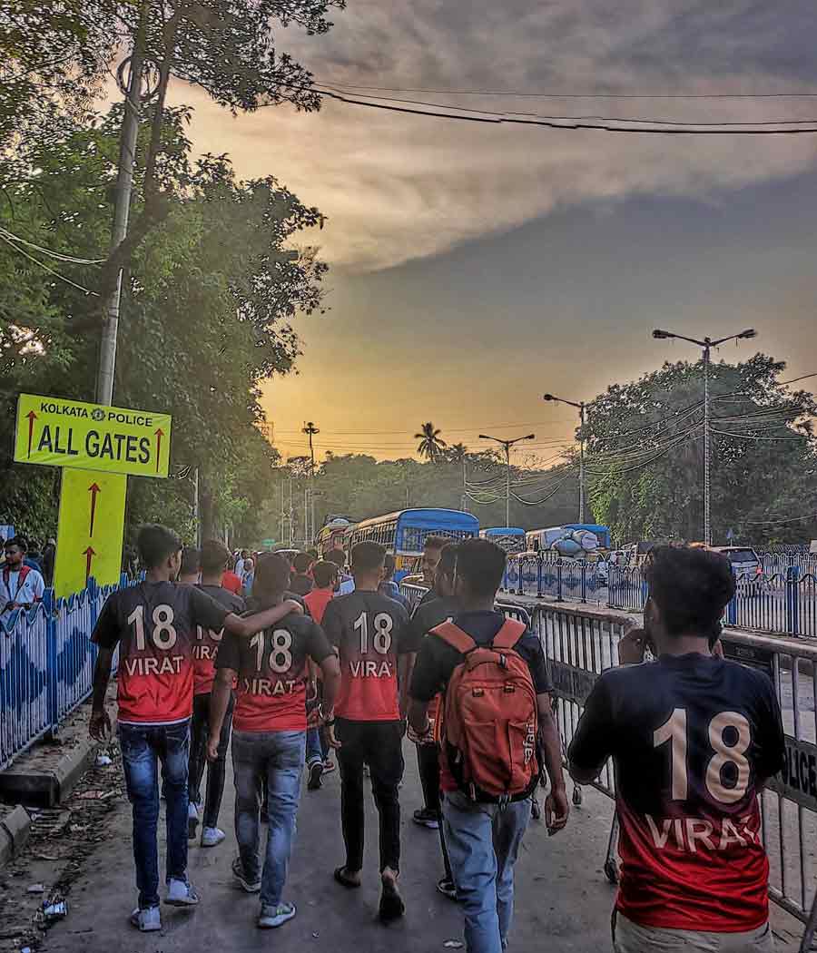 Fans wearing “Kohli” jerseys head for the stadium gates. All eyes are on Virat Kohli in the blockbuster encounter