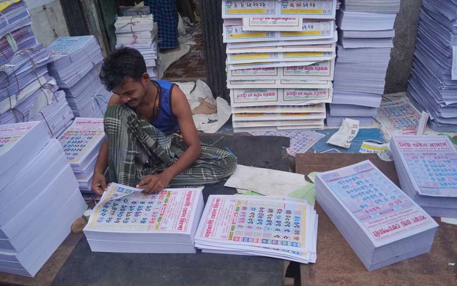 A man checks Bengali calendars on Saturday ahead of Poila Baisakh