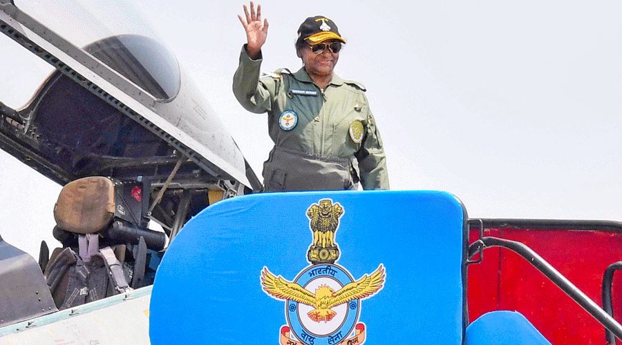 Murmu, supreme commander of the Indian Armed forces, waves after taking the sortie on the IAF’s fighter aircraft.