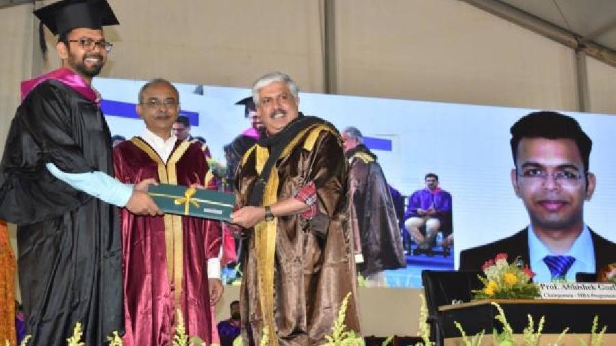 A student receives his degree from chairperson, IIM-Calcutta board of governors, Shrikrishna Kulkarni during the convocation on Saturday as IIM-Calcutta director Uttam Kumar Sarkar (centre) looks on