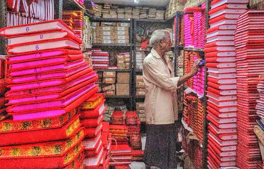 A man gets his stock of haalkhata at Baithakkhana Market ahead of Poila Baishakh. Traditionally, businesses start their new accounts on Nabo Borsho 