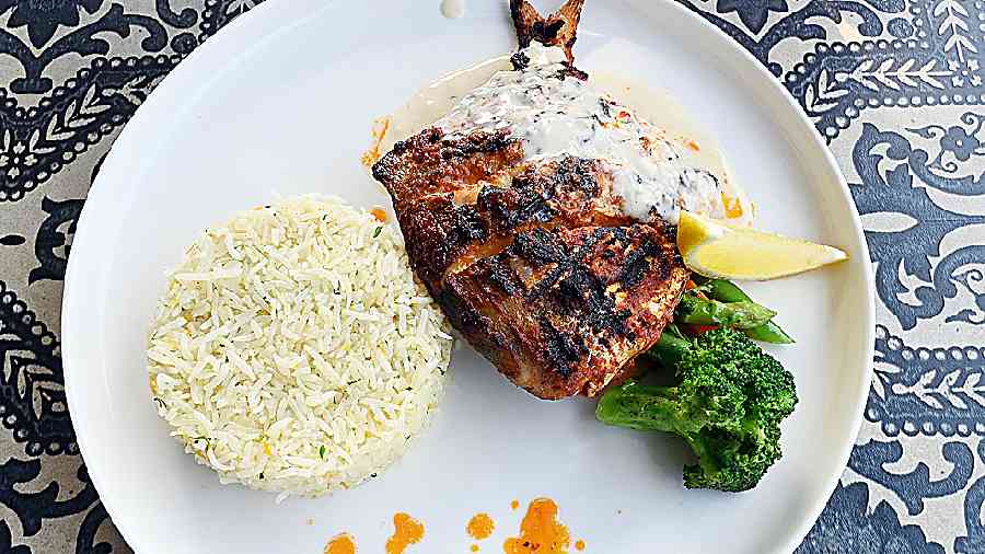 Harissa Grilled Pomfret: Seafood lovers rejoice, this harissa-rubbed pomfret is grilled to perfection. We love the simple lemon rice on the side served with grilled veggies and creamy garlic sauce.