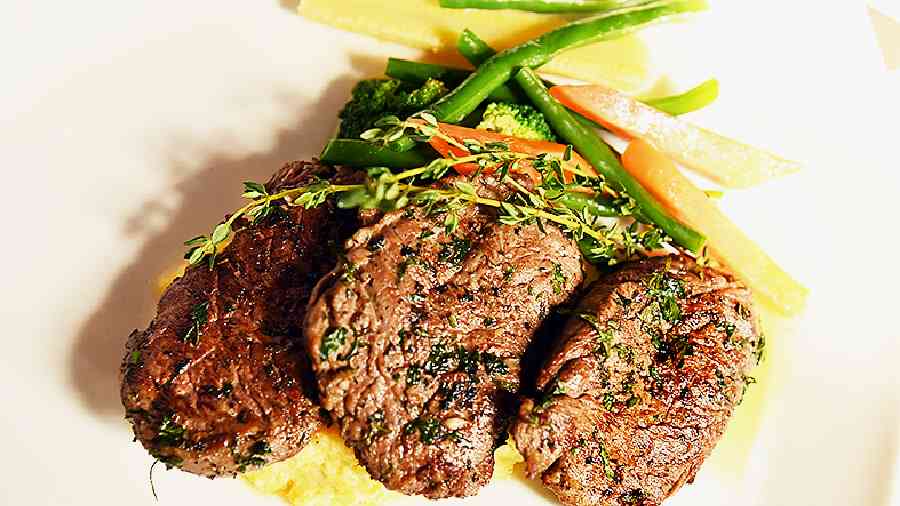 Beef Filet Mignon With Mustard Mushroom Sauce, where the perfectly roasted beef tenderloin is served with polenta and sauteed vegetables.