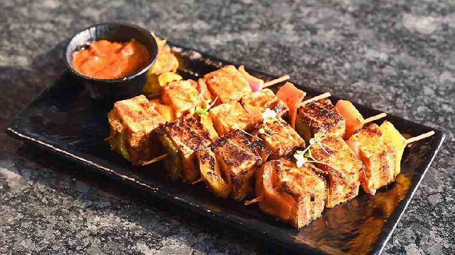 Paneer Shaslik is made with soft cubes of cottage cheese tossed in a spicy sauce made with soy, chilli and vinegar sauce and grilled to perfection. Served in skewers.