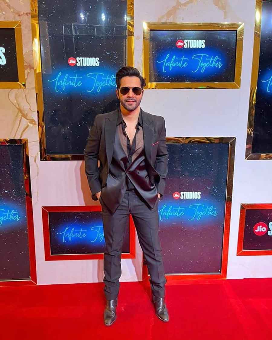 Varun Dhawan opted for a sheer shirt underneath his black suit. The actor will soon be seen in a sequel to Bhediya opposite Kriti Sanon. 