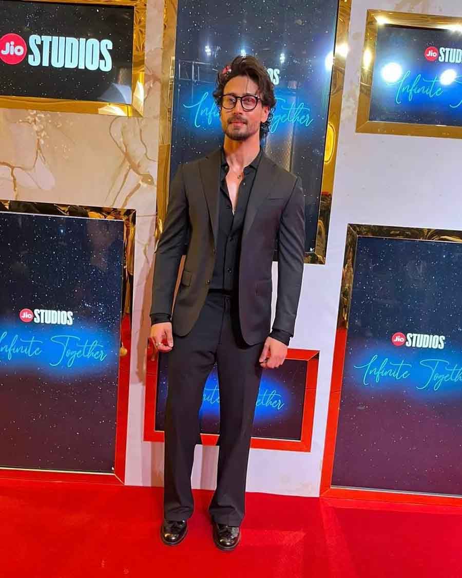 Tiger Shroff looked dapper in a classic black suit paired with a matching shirt underneath.
