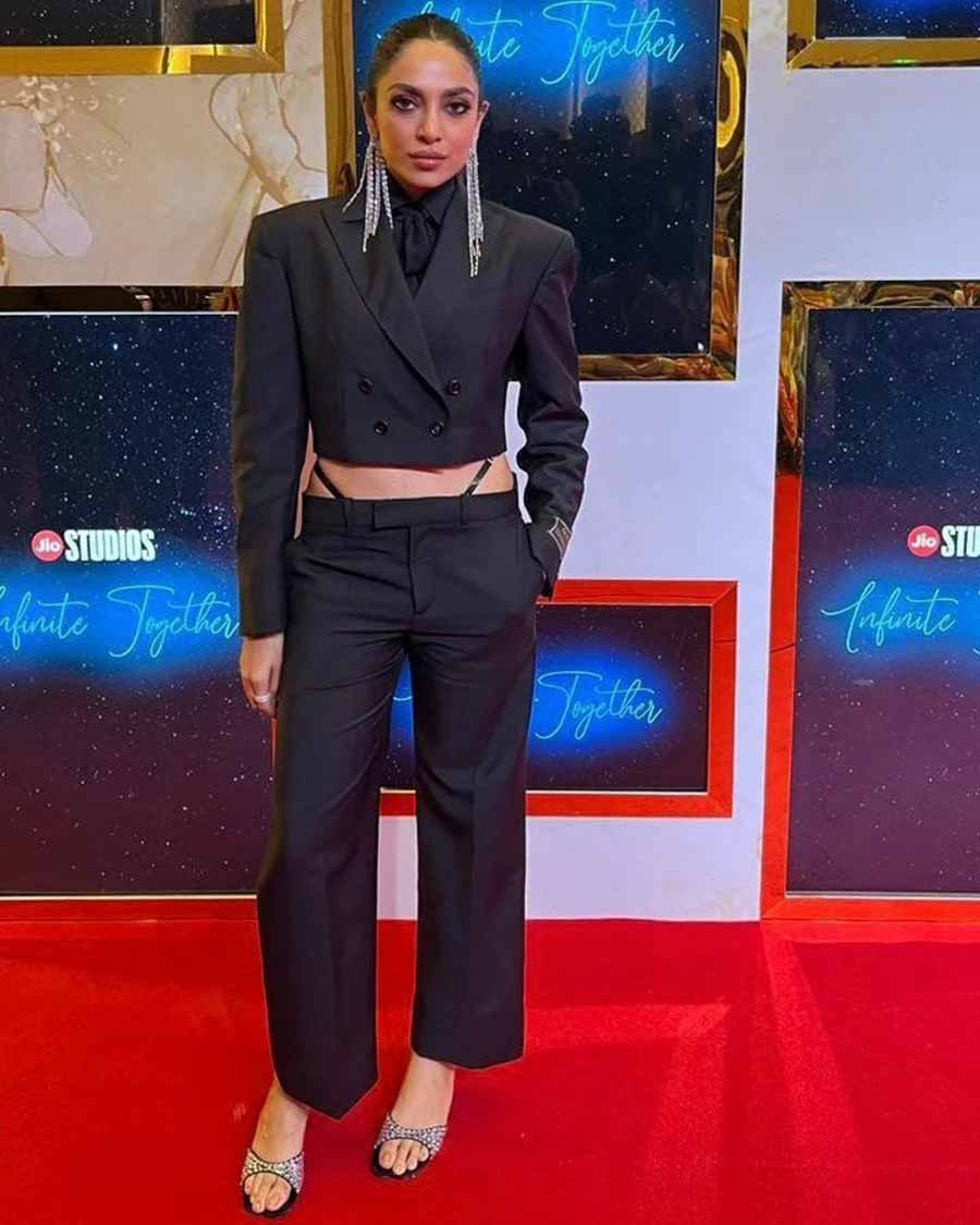Sobhita Dhulipala made a fashion statement in a black Gucci co-ord set — a cropped blazer and matching trousers with the iconic G-string accessory and shimmery earrings. 