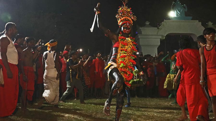 A devotee dressed as Kali, one of the Hajras, brandishing his weapon while circulating the Charak Tree