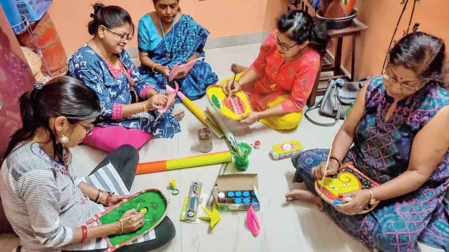 Women of CA Block, New Town, busy creating origami figures