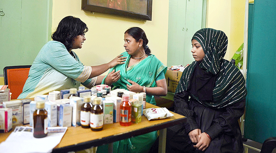 A doctor checks a patient at the clinic.