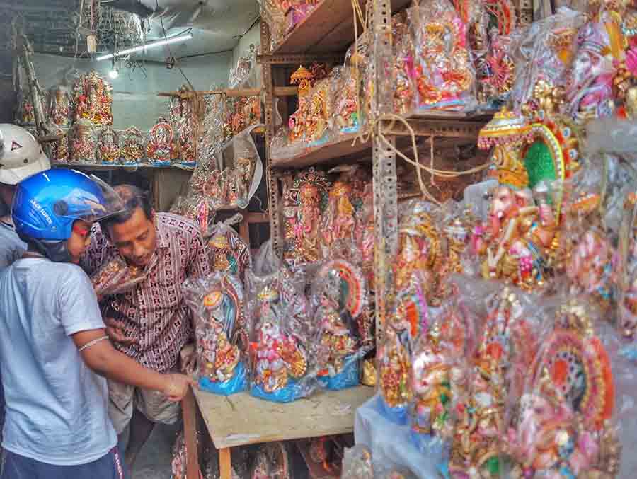 People taking home idols of Ganesh and Lakshmi on the eve of Nabo Borsho on Friday   