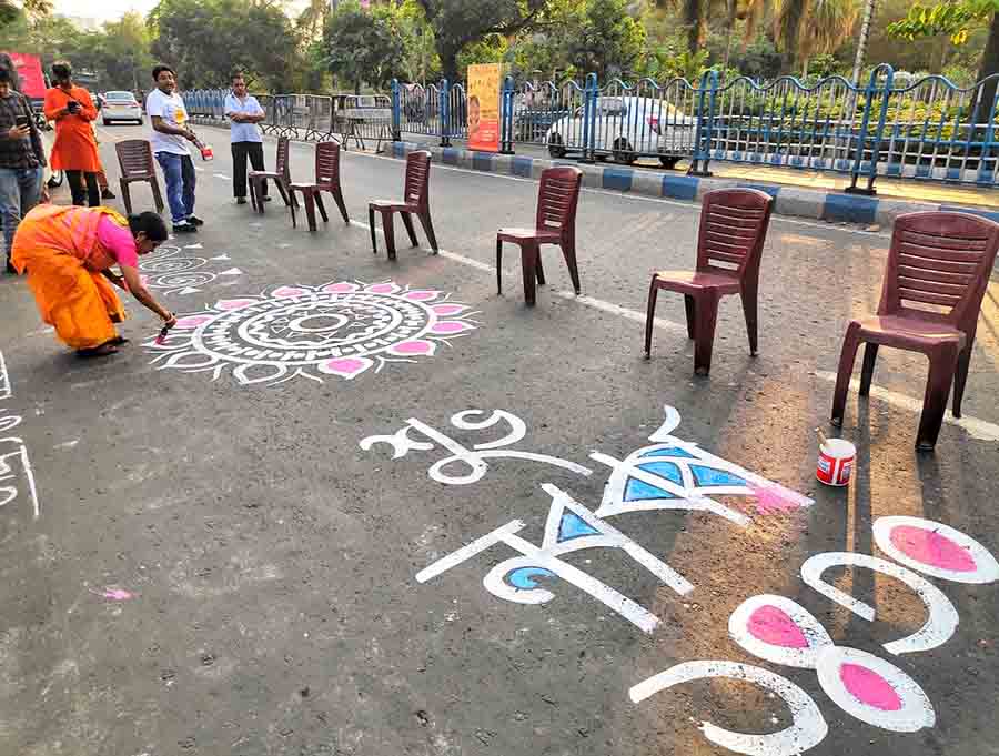 Alpana drawn by artists on the street near Nandan on Friday ahead of Poila Baishak  