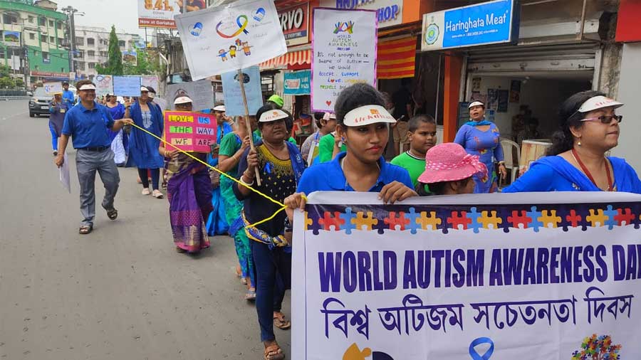 Students and staff members of Alokdhara Inclusive Montessori School take part in a rally on World Autism Day