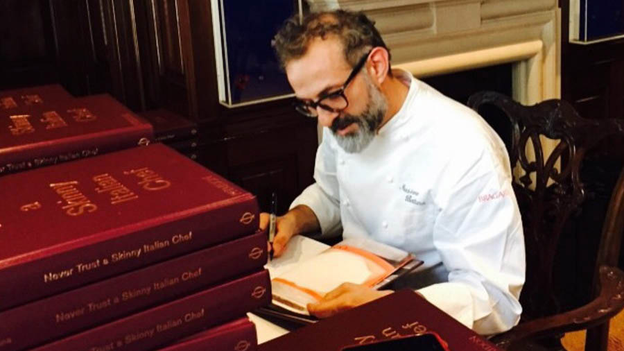 Bottura signing copies of his book ‘Never Trust a Skinny Italian Chef’ released in 2014 