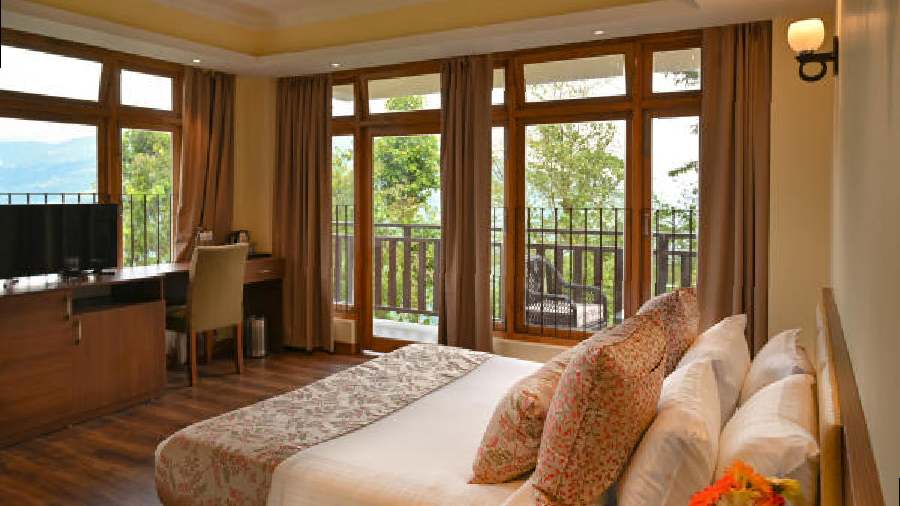 A premier room with large front windows and a private balcony offers a breathtaking view of the mountains.