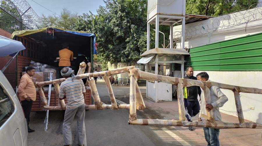 Workers load goods in a truck as Congress leader and former Lok Sabha MP Rahul Gandhi vacates his official bungalow, in New Delhi on Friday.