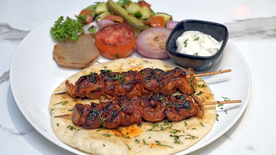 Turkish Chicken Shaslik Platter has grilled chicken shashlik served on house-made pita bread, salad and house-special dip.