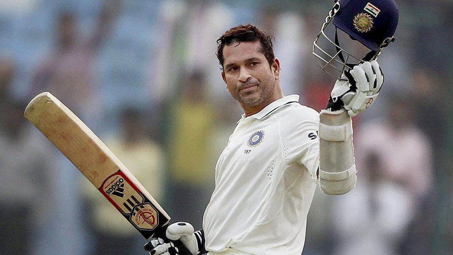 The cricketer celebrates his 15,000 runs during the third day of the first cricket test match against West Indies, in New Delhi on November 8, 2011. 
