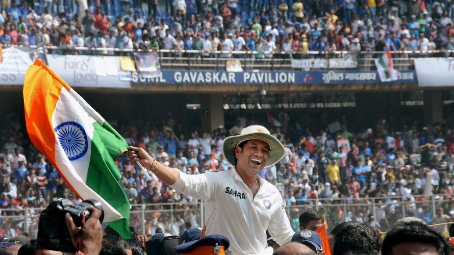 The legendary cricketer waves the tri-colour during his farewell ceremony at Wankhede stadium in Mumbai on November 16, 2013. 