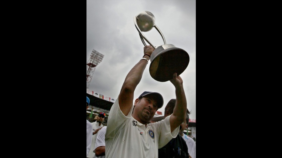 In this Wednesday, Oct. 13, 2010 file photo, Tendulkar jubilates with the Gavaskar-Border trophy after Team India's win in the 2nd test match against Australia at Chinnaswamy Stadium in Bengaluru. India won the series 2-0 and Tendulkar was declared 'Man of the Series'.