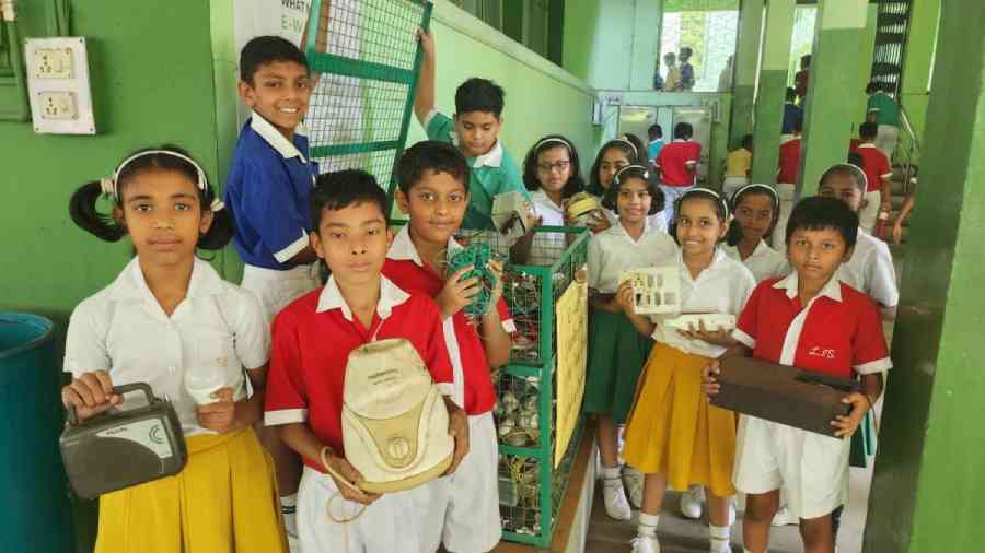 Students show the recyclable waste in their school in Jamshedpur.