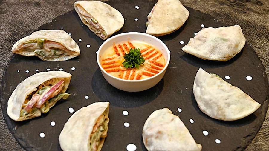 Falafel Pita Pockets with Hummus Dip, where falafel balls with creamy veggies are stuffed in homebaked pita bread, is the club’s signature dish. Rs 395