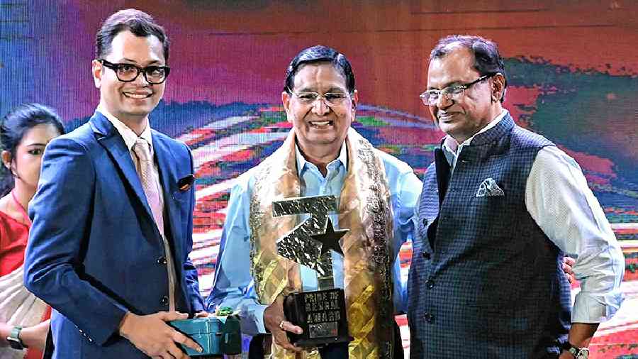 Chairman of CenturyPly Sajjan Bhajanka (right) and Arihant Parakh handed over the lifetime achievement award to Prahlad Rai Agarwala (centre). “I have lived in Bengal for many years. I enjoy working here. I love the people, the culture and their language. But today, I only want to tell everyone — stay happy and move forward towards your goal,” the veteran businessman said.