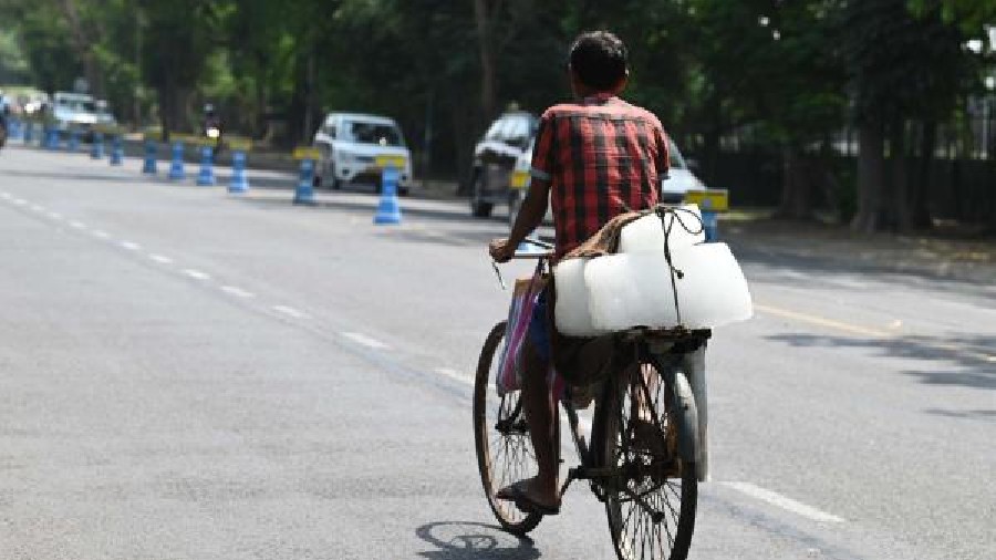A block of ice being transported on a bicycle on Mayo Road on Friday