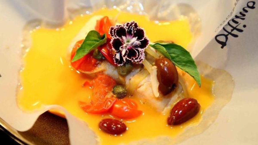 Ligurian-style Poached Sea Bass: This Italian delicacy has the freshness from capers, the crunch of celery and the fatty taste of Kalamata olives. The sea bass is poached in quintessential Ligurian style within a foil.