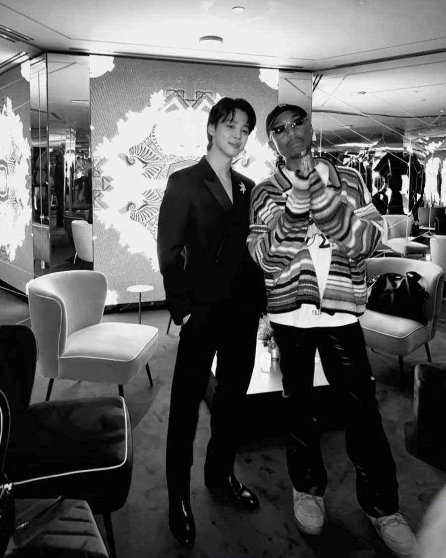 The BTS member also struck a pose with rapper Pharrell Williams during the event. 