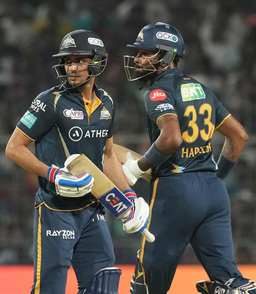 Gujarat Titans batter Shubman Gill and Hardik Pandya cross each other to complete a run during the match between KKR and GT at Eden Gardens in Kolkata on Saturday