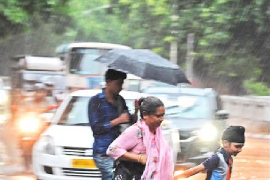 Pedestrians caught in rain on Outram Road on Tuesday afternoon.