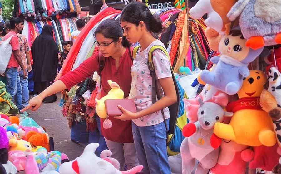 Two young women buy teddy bears at Esplanade on the eve of Friendship Day 