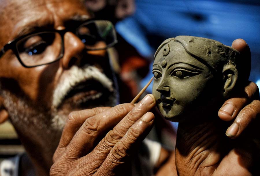 With less than three months left for Durga Puja, Kumartuli artisans are racing against time to complete the idols, especially the ones meant for outstation destinations. On Monday, an artist was seen working on a miniature face of Durga  