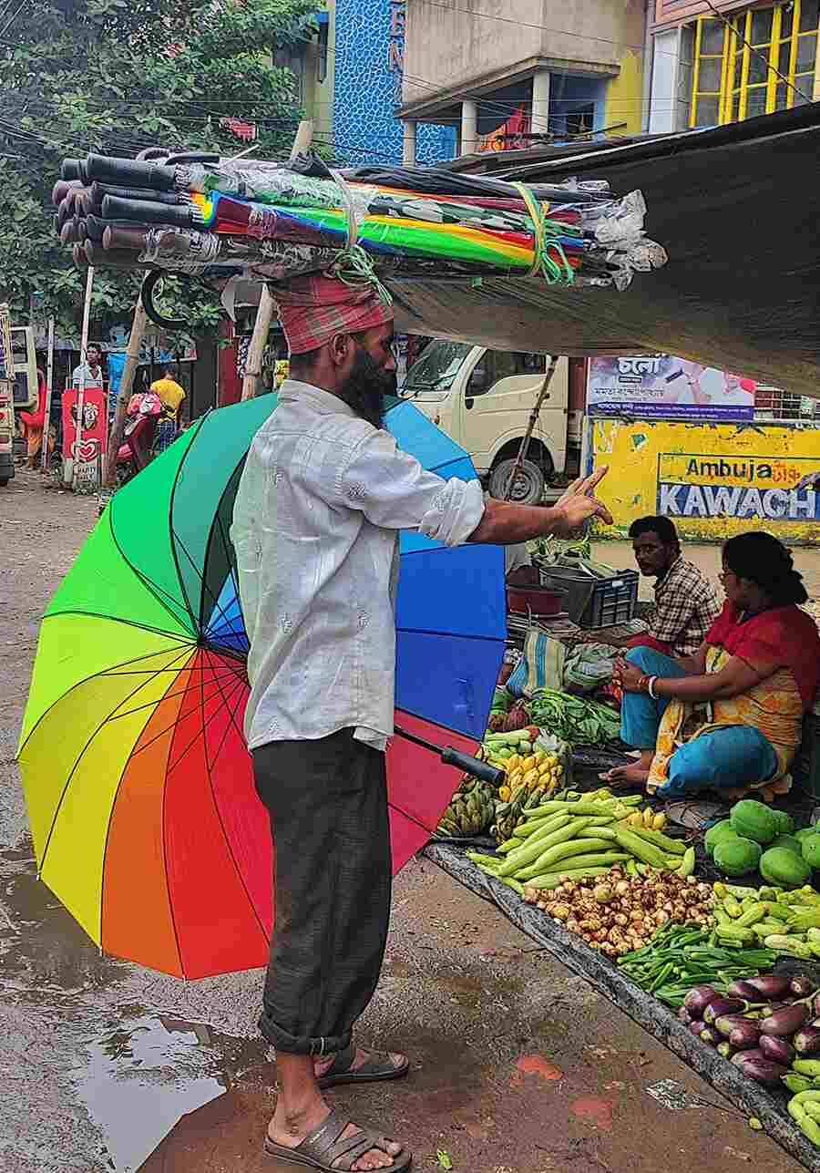 As the frequency of rain increases in Kolkata, a man roams the city streets repairing umbrellas 