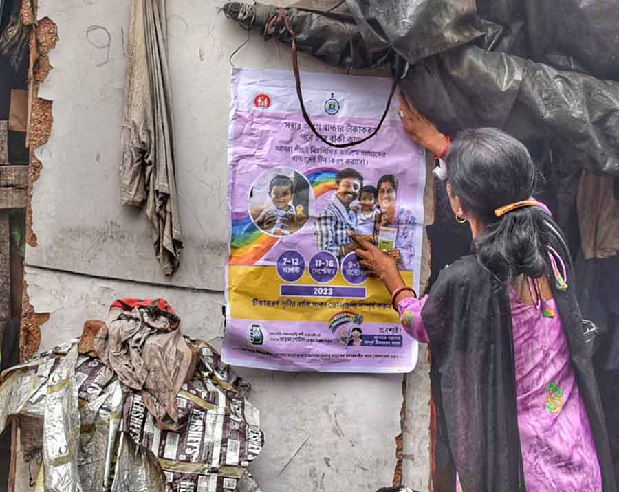 A woman was seen pasting a poster of Mission Indradhanush on Friday. Through the mission via U-Win portal, the health department of West Bengal aims to safeguard the health and well-being of children and pregnant women by providing them with essential vaccinations and immunisation services, contributing to disease prevention and a healthier community