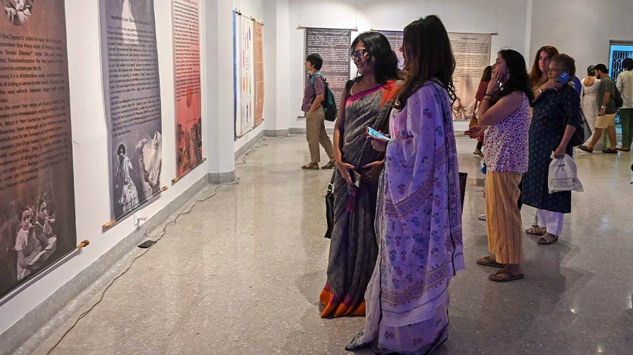 Visitors looking at an informative installation on saris set up in the Birla gallery