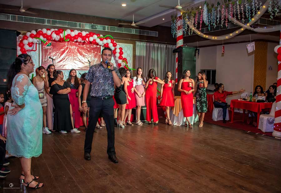 BEHIND THE SCENES: Guiding the festivities were Blossom Rae, the club’s general secretary, and Nigel Vincent, honorary social secretary & master of ceremonies for the evening. The grand cake, a generous contribution from Taj Bengal, stood as a symbol of togetherness