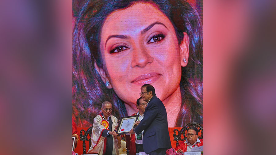 Narayana Murthy does the honours even as an image of Sushmita Sen is seen in the background