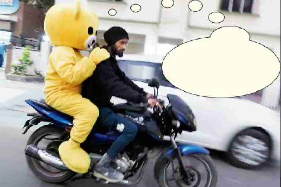 What is the pillion rider in yellow costume thinking?