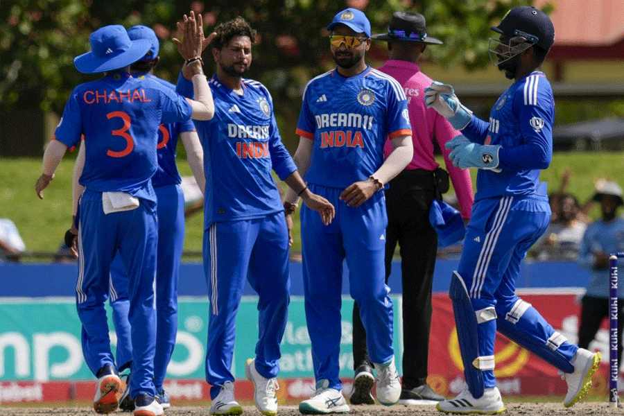 Kuldeep Yadav (second from left) with teammates after dismissing Nicholas Pooran for 1 on Saturday, as India look to level the series with one game to go.