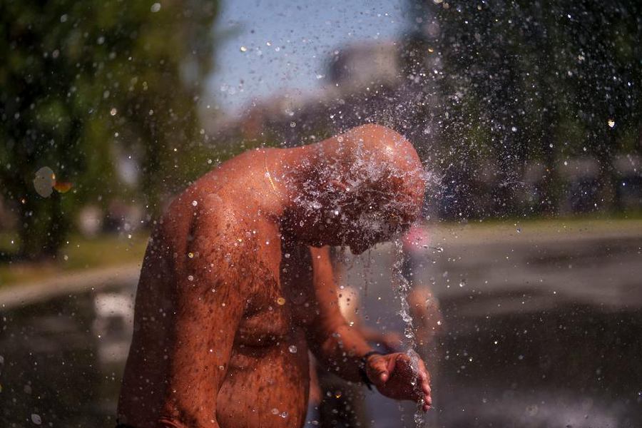 People around the world have been forced to cool off any way they can, including this man at an urban beach in Madrid