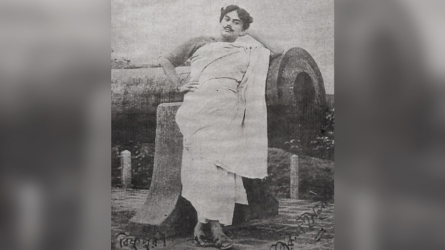 A young Nazrul Islam in front of the Dolmadol canon in Bishnupur in the 1920s 