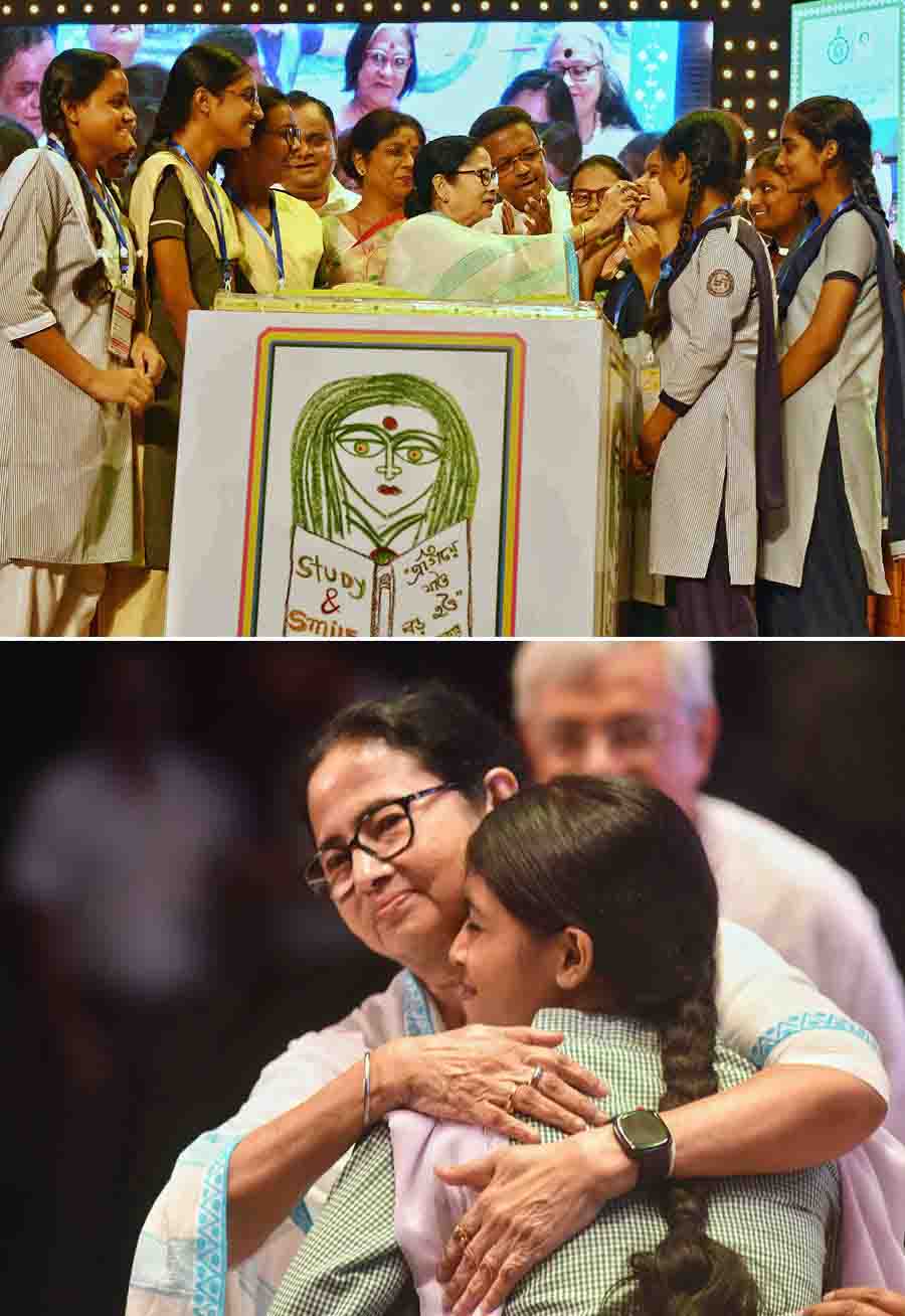(Top) The Department of Women and Child Development and Social Welfare hosted the 10th Kanyashree Day at Dhono Dhanya Auditorium in Alipore on Monday and (above) chief minister Mamata Banerjee hugs a youngster at the venue  