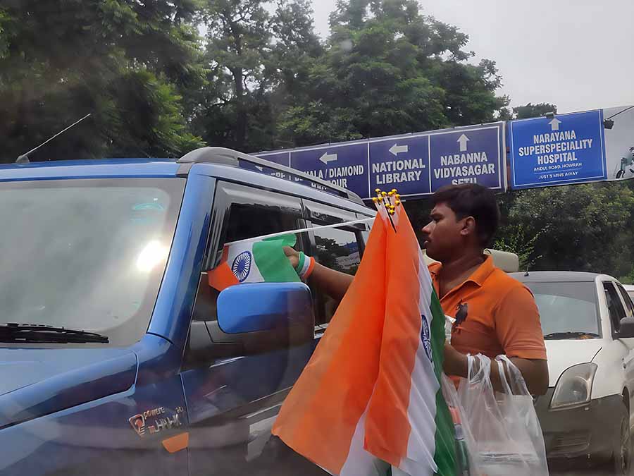 Vendors selling Tricolour badges and flags near the Race Course  