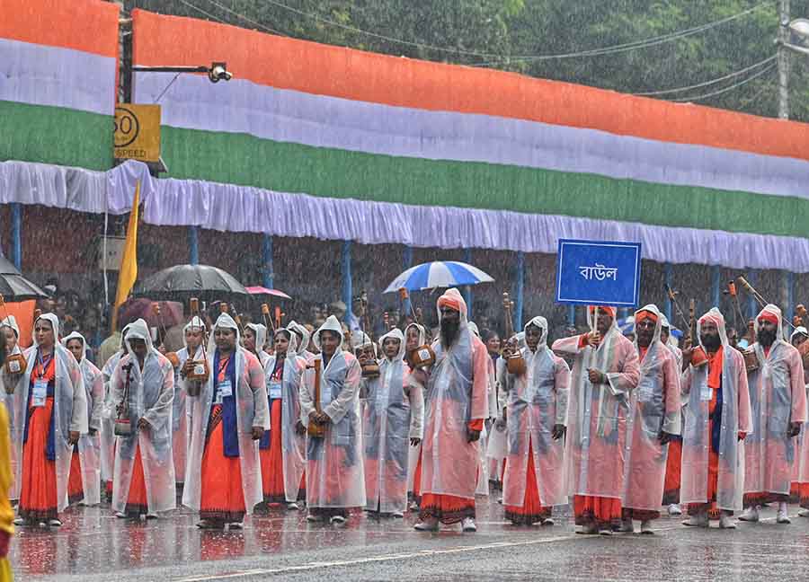 In order to beat the morning showers, bauls wore raincoats as they participated in a march on Red Road 