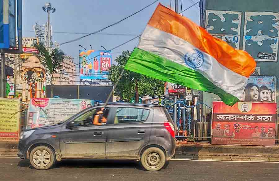 A car went around the city bearing the National Flag 