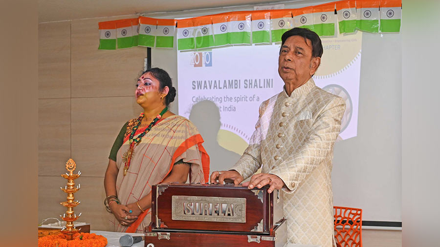 Arundhati Sen and (right) Parimal Chandra Das begin the opening ceremony with a rendition of the National Anthem