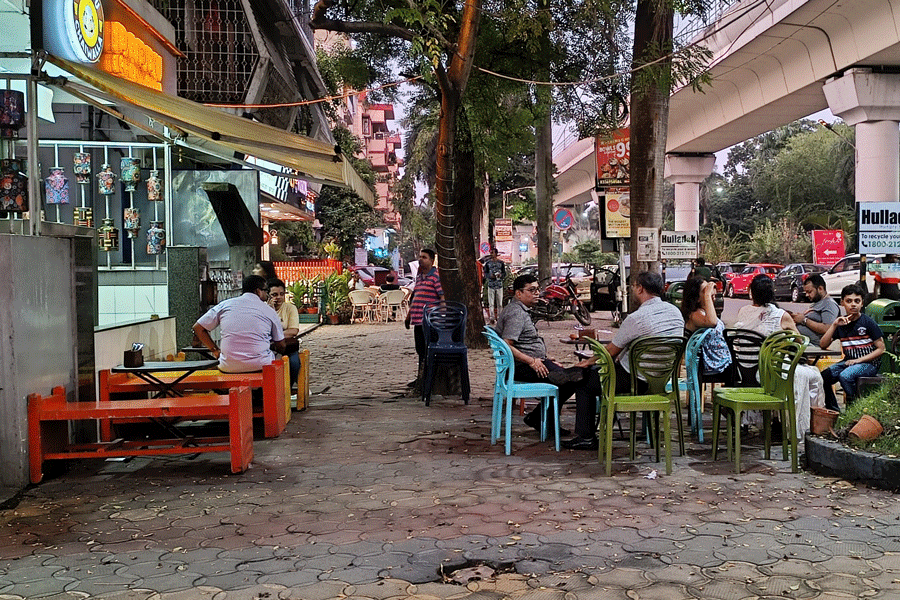Diners sit on the pavement of DB Block eateries.